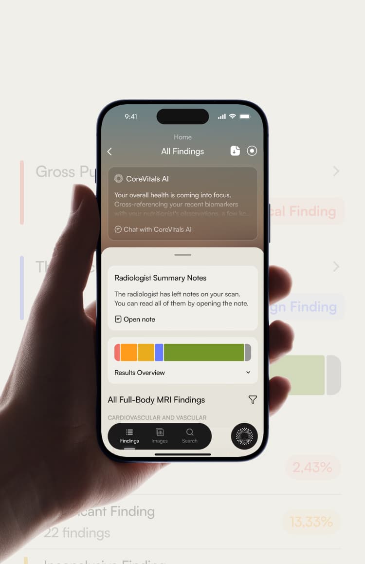 A hand holding a phone showing scan findings and blood results in the CoreVitals app